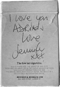 Start of image description, A handwritten message from Jennifer to Adrian is written on the back of a packet of Silk Cut cigarettes. The message reads, I love you Adrian, love Jennifer. The message is accompanied by 3 kisses., end of image description