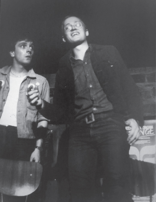 Start of image description, Adrian laughs during a performance at the Fringe Club in Edinburgh. Rik looks on with a confused expression., end of image description